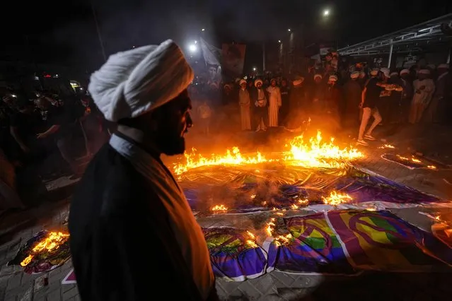 Supporters of Shiite Muslim leader Moqtada Sadr burn rainbow flags, during a demonstration in Sadr City, in response to the burning of Quran in Sweden, Baghdad, Iraq, Wednesday, July 12, 2023. (Photo by Hadi Mizban/AP Photo)