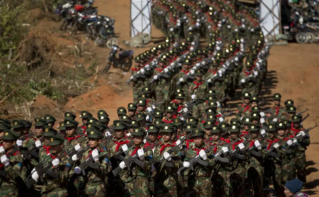 In this January 12, 2015 photo, Ta’ang National Liberation army troops march in Mar Wong Village, northern Shan state during a celebration marking the 52nd anniversary of their insurrection against successive Myanmar governments. (Photo by Gemunu Amarasinghe/AP Photo)