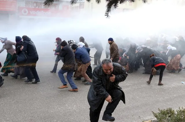 Riot police spray tear gas and water cannons at pro-Kurdish demonstrators during a protest against security operations in the Kurdish-dominated southeast, in Van, Turkey, January 11, 2016. (Photo by Bedran Babat/Reuters)