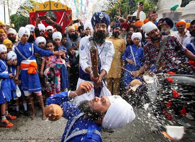 Sikh devotees perform Gatka, a traditional martial arts form during celebrations to mark the 414th anniversary of the installation of the Guru Granth Sahib, the religious book of Sikhs, in Amritsar, India, September 10, 2018. (Photo by Munish Sharma/Reuters)