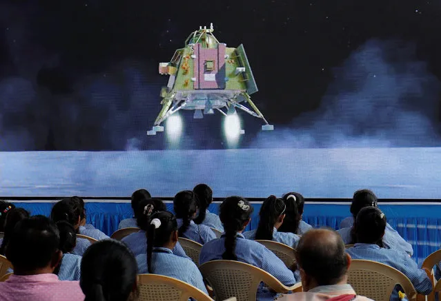 People watch a live stream of Chandrayaan-3 spacecraft's landing on the moon, inside an auditorium of Gujarat Science City in Ahmedabad, India on August 23, 2023. (Photo by Amit Dave/Reuters)