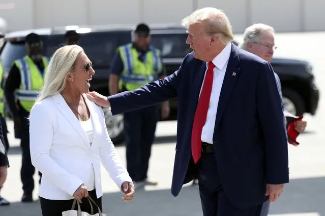 Former President Donald Trump is greeted by Rep. Majorie Taylor Greene, R-Ga., as he arrives at Atlantic Aviation CHS in North Charleston, S.C., Monday, September 25, 2023. (Photo by Artie Walker Jr./AP Photo)