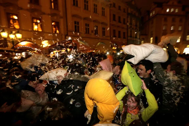 People take part in a four-minute flash mob pillow fight at the Old Town Square in Prague, Czech Republic, December 22, 2016. (Photo by David W. Cerny/Reuters)