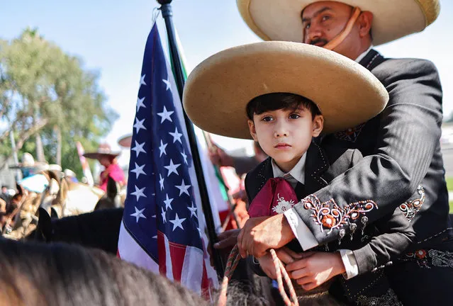 Miguel Angel and Aurelio Perez Montiel sit on horseback with an American flag at the Festival Monarca, which was held for the first time since the COVID-19 pandemic, on September 24, 2023 in Perris, California. The festival celebrates Mexican Independence Day and the Day of the Mexican Cowboy and Cowgirl while honoring the local immigrant community. The festival is named after the famous Monarch migratory butterfly and was organized by TODEC Legal Center, an immigrant advocacy organization, which also celebrated its 39th anniversary at the event. (Photo by Mario Tama/Getty Images)
