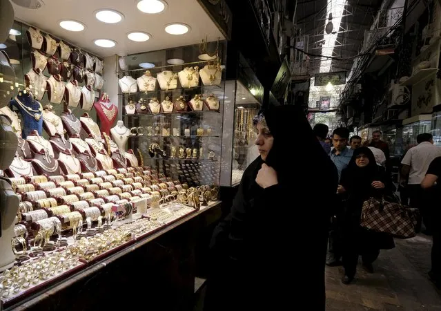 A woman looks at jewelry  in a shop at the Grand Bazaar in central Tehran October 7, 2015. (Photo by Raheb Homavandi/Reuters/TIMA)