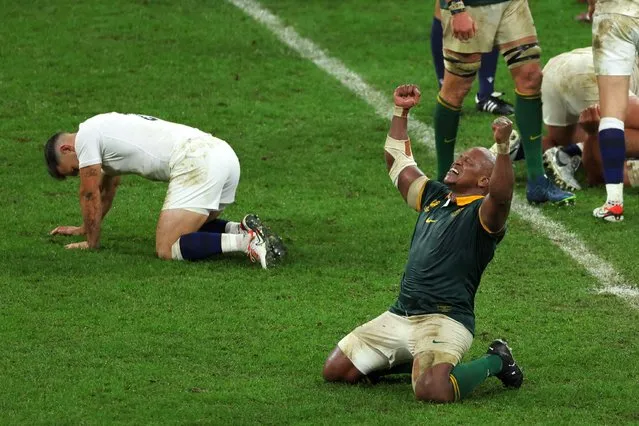 South Africa's hooker Bongi Mbonambi (R) raises his arms and sinks to his knees as he celebrates South Africa's victory at the end of the France 2023 Rugby World Cup semi-final match between England and South Africa at the Stade de France in Saint-Denis, on the outskirts of Paris, on October 21, 2023. (Photo by Thomas Samson/AFP Photo)