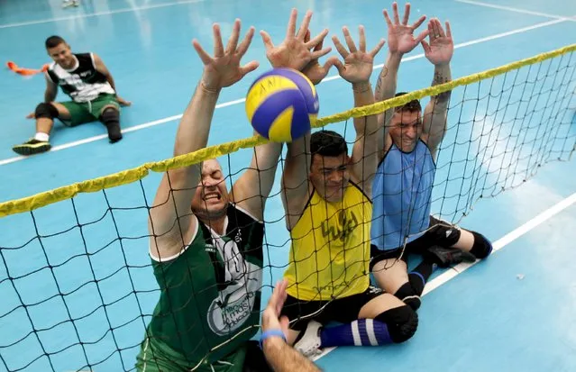 National Army of Colombia soldiers, who were wounded by mines, play sitting volleyball in Bello, municipality of Antioquia, March 25, 2015. (Photo by Fredy Builes/Reuters)