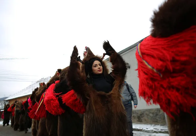 Dancers wearing costumes made of bearskins dance in the village of Asau, Romania December 30, 2016. (Photo by Stoyan Nenov/Reuters)