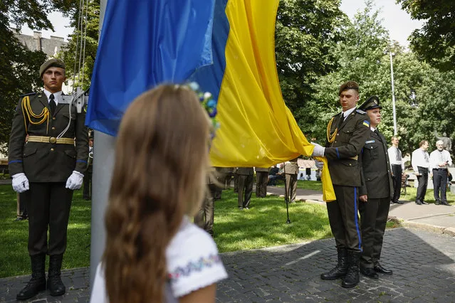 Dignitaries and members of the public attend a ceremony in the Na Valakh park on Independence Day of Ukraine on August 24, 2022 in Lviv, Ukraine. This year, Ukraine's Independence Day, commemorating its break with the Soviet Union in 1991, coincides with the six-month mark since Russia launched its large-scale invasion of the country. The fighting has largely focused on the eastern Donbas region and the south, but most anywhere in Ukraine remains vulnerable to Russian air strikes. (Photo by Jeff J. Mitchell/Getty Images)