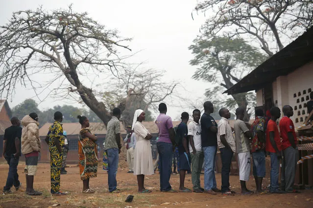People line up to cast their ballots in the second round of presidential election and the first round of legislative elections in the Fatima district of Bangui, Central African Republic, Sunday February 14, 2016. Two former prime ministers, Faustin Archange Touadera and Anicet Georges Dologuele, are running neck-and-neck in the second round of presidential elections to end years of violence pitting Muslims against Christians in the Central African Republic. Central Africans will also vote in Legislative elections. (Photo by Jerome Delay/AP Photo)