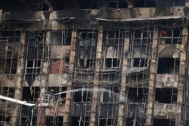 Efforts are made to douse a fire that broke out at a police facility, in Ismailia, Egypt on October 2, 2023. (Photo by Mohamed Abd El Ghany/Reuters)