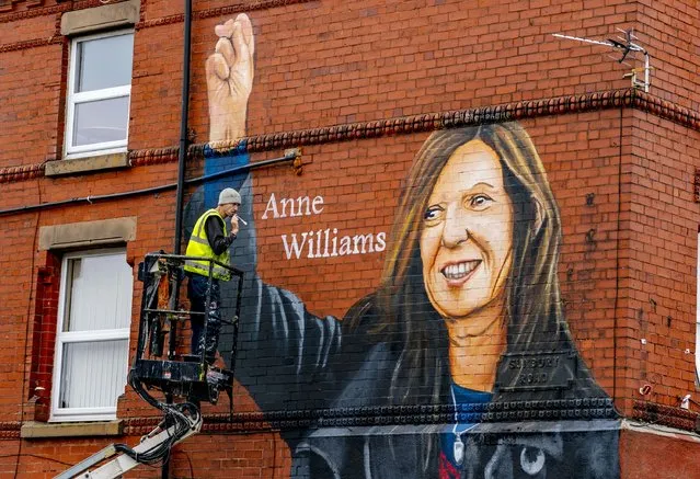 Artist Paul Curtis paints a mural of Anne Williams, the mother of Hillsborough victim Kevin Williams, on a building in the Anfield area of Liverpool on Wednesday, August 18, 2021. (Photo by Peter Byrne/PA Wire Press Association)