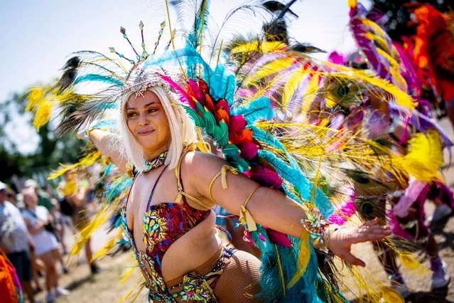 Notting Hill Carnival performers pass through the site at the Glastonbury Festival in Worthy Farm, Somerset, England, Thursday, June 22, 2023. (Photo by Scott Garfitt/Invision/AP Photo)