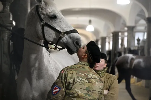People prepare horses in the royal stables at Christiansborg Palace, on the day Denmark's Queen Margrethe abdicates after a reign of 52 years and her elder son, Crown Prince Frederik, ascends the throne as King Frederik X in Copenhagen, Denmark, on January 14, 2024. (Photo by Nils Meilvang/Ritzau Scanpix via Reuters)