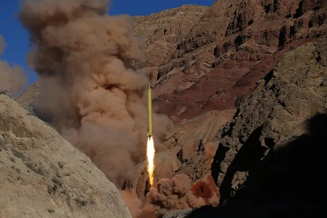 In this photo obtained from the Iranian Fars News Agency, a Qadr H long-range ballistic surface-to-surface missile is fired by Iran's powerful Revolutionary Guard, during a maneuver, in an undisclosed location in Iran, Wednesday, March 9, 2016. Irans powerful Revolutionary Guard test-fired two ballistic missiles Wednesday with the phrase “Israel must be wiped out” written on them, a show of deterrence power by the Islamic Republic as U.S. Vice President Joe Biden visited Israel, the semi-official Fars news agency reported. (Photo by Omid Vahabzadeh/AP Photo/Fars News Agency)