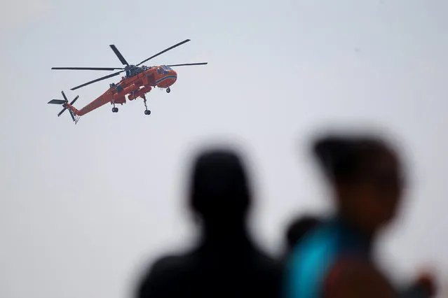 A fire fighting helicopter “Sky crane” is seen at Santiago's airport during its arrival to help to extinguish wildfires in Chile's central-south regions, Chile February 2, 2017. (Photo by Ivan Alvarado/Reuters)