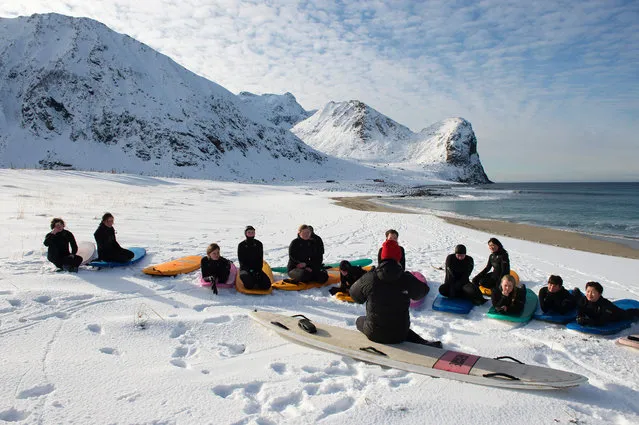 A group of beginner surfers from Norway attend their 1st course at snowy beach of Unstad, Norway on Lofoten Island, Arctic Circle, on March 9, 2016. (Photo by Olivier Morin/AFP Photo)