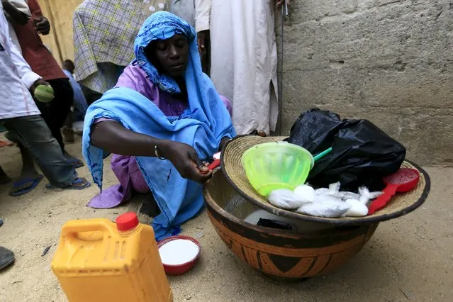 A woman sells milk at a community of internally displaced people in Maiduguri, Nigeria, March 9, 2016. (Photo by Afolabi Sotunde/Reuters)