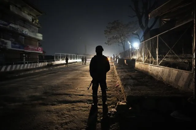 An Indian paramilitary soldier stands guard near the site of a shootout in Srinagar, Indian controlled Kashmir, Wednesday, February 7, 2024. Assailants fatally shot a non-local worker and wounded another in the main city of Indian-controlled Kashmir late Wednesday, police said and blamed militants fighting against Indian rule in the disputed region for the attack. (Photo by Mukhtar Khan/AP Photo)