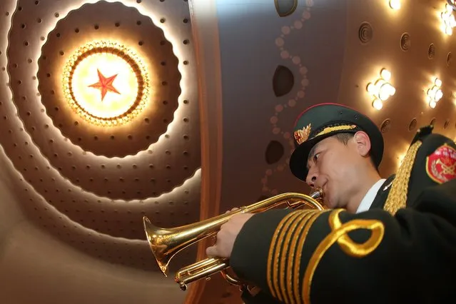 A member of the military band practices during rehearsal ahead the closing of the fourth Session of the 12th National People's Congress (NPC) at the Great Hall of the People in Beijing, China, 16 March 2016. The NPC has over 3,000 delegates and is the world's largest parliament or legislative assembly though its function is largely as a formal seal of approval for the policies fixed by the leaders of the Chinese Communist Party. (Photo by Wu Hong/EPA)