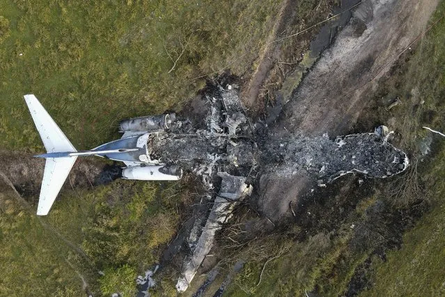 The remnants of an aircraft, which caught fire soon after a failed take-off attempt at Houston Executive Airport, are seen just north of Morton Road on Tuesday, October 19, 2021, in Brookshire. Texas. (Photo by Godofredo A. Vásquez/Houston Chronicle via AP Photo)