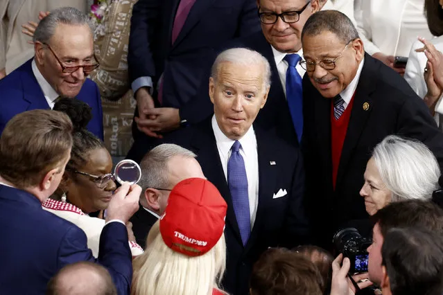 U.S. President Joe Biden reacts as he looks at U.S. Representative Marjorie Taylor Greene (R-GA) as he arrives in the chamber before delivering the State of the Union address at the U.S. Capitol in Washington, D.C., March 7, 2024. (Photo by Evelyn Hockstein/Reuters)
