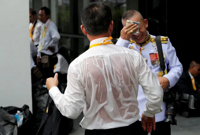 A journalist is seen soaked in sweat as he waits outside the balcony of Suddhaisavarya Prasad Hall at the Grand Palace, where of King Maha Vajiralongkorn will grant a public audience to receive the good wishes of the people in Bangkok, Thailand May 6, 2019. (Photo by Jorge Silva/Reuters)