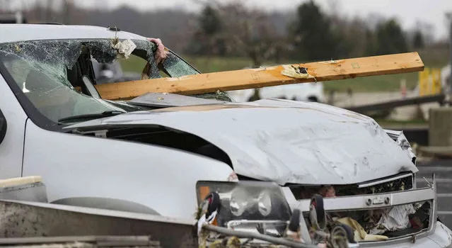 Cars are left damages after a severe storm from the night before Friday, March 15, 2024, in Winchester, Ind.  Severe storms with suspected tornadoes have damaged homes and businesses in the central United States. (Photo by Grace Hollars/The Indianapolis Star via AP Photo)