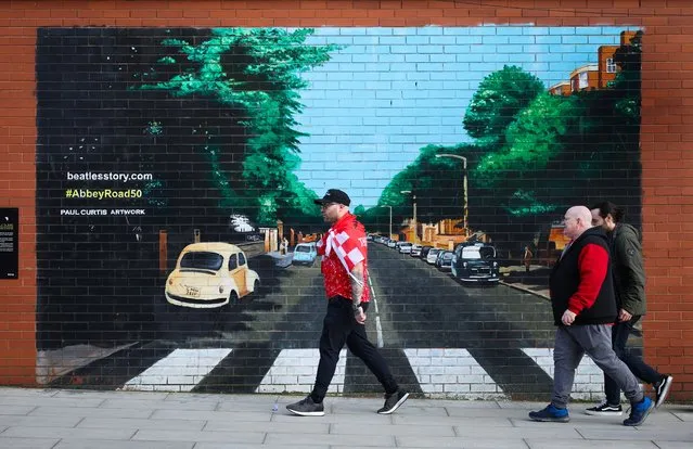 Liverpool fans walk past a mural of the Beatle’s Abbey Road album ahead of the Carabao Cup final match between Liverpool and Chelsea at the Camp and Furnace venue in Liverpool, Britain, 25 February 2024. (Photo by Adam Vaughan/EPA)