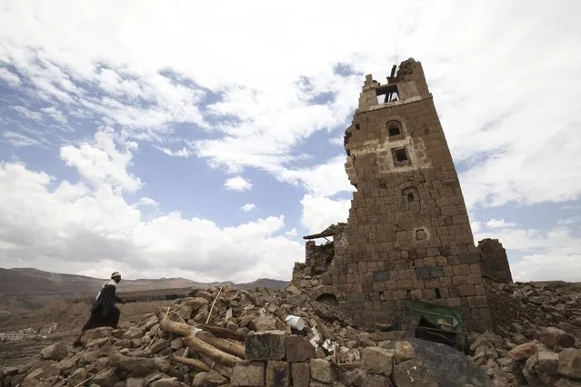 A man walks to a house that was damaged during an airstrike carried out by the Saudi-led coalition in Faj Attan village, Sanaa, Yemen May 7, 2015. (Photo by Mohamed al-Sayaghi/Reuters)