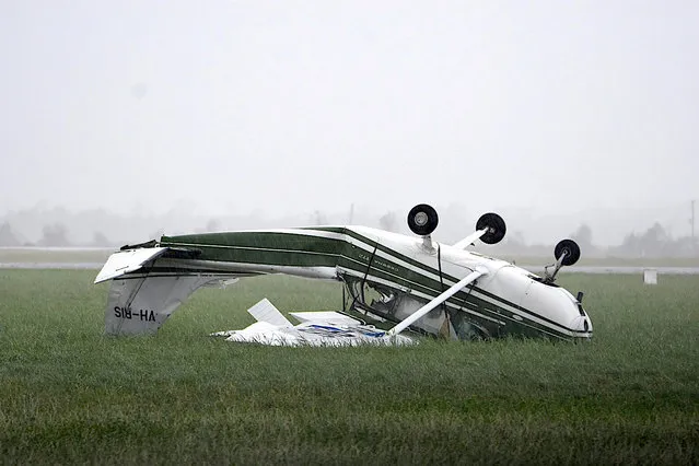 A plane that was flipped by strong winds from Cyclone Debbie is seen at the airport in the town of Bowen, Australia, Wednesday, March 29, 2017. (Photo by Sarah Motherwell/Reuters/AAP)