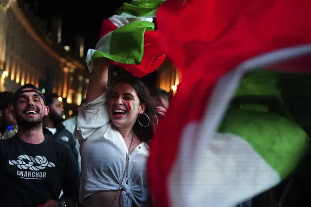 Italy fans celebrate in Piccadilly Circus in central London after their team won the UEFA Euro 2020 Final against England, Sunday July 11, 2021. (Photo by Victoria Jones/PA Wire via AP Photo)