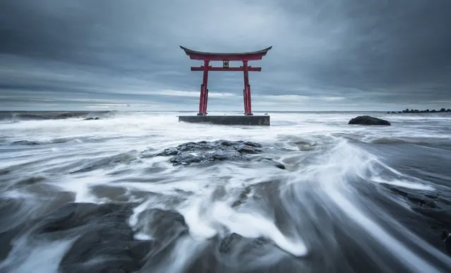“Torrent”. “Torii” built as a marine guardian deity. It is a building which symbolizes Japan. A long time ago, there is a legend that the wreck at sea decreased greatly, thanks to this torii. Photo location: Shosanbetsu,Hokkaido, Japan. (Photo and caption by Mitsuhiko Kamada/National Geographic Photo Contest)