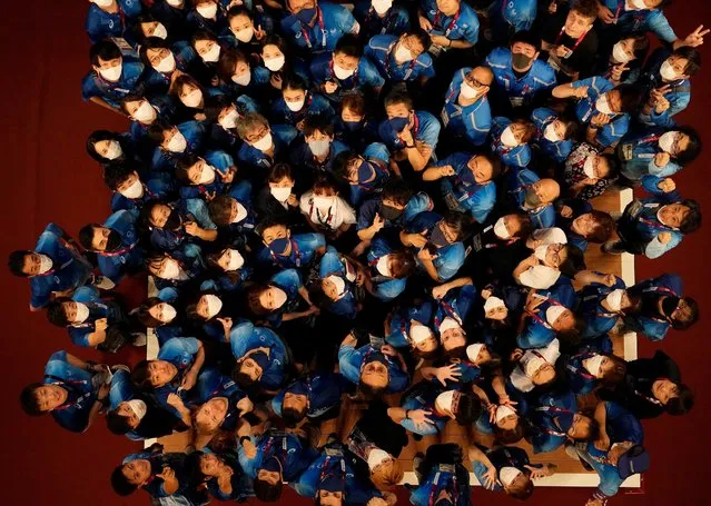 Olympic staff pose for a picture at the weightlifting event at the Tokyo International Forum, at the 2020 Summer Olympics, Wednesday, August 4, 2021, in Tokyo, Japan. (Photo by Luca Bruno/AP Photo)