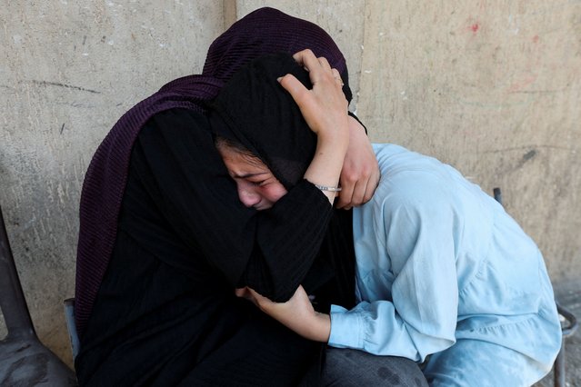 Palestinian women react after an Israeli air strike on a UN school sheltering displaced people, amid the Israel-Hamas conflict, in Nusairat in central Gaza Strip, on July 14, 2024. (Photo by Ramadan Abed/Reuters)