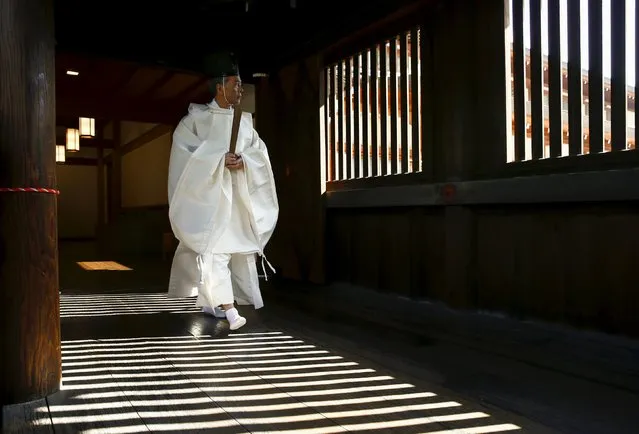 A Shinto priest walks in a corridor of the Yasukuni shrine before the visit of a group of Japanese lawmakers in Tokyo, Japan April 22, 2016. (Photo by Thomas Peter/Reuters)