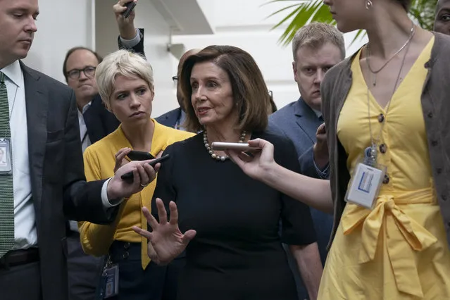 Speaker of the House Nancy Pelosi, D-Calif., is surrounded by reporters as she arrives to meet with her caucus the morning after declaring she will launch a formal impeachment inquiry against President Donald Trump, at the Capitol in Washington, Wednesday, September 25, 2019. (Photo by J. Scott Applewhite/AP Photo)