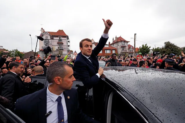 French presidential election candidate Emmanuel Macron, head of the political movement En Marche !, or Onwards ! greets supporters as leaves a polling station during the the second round of 2017 French presidential election, in Le Touquet, France, May 7, 2017. (Photo by Philippe Wojazer/Reuters)