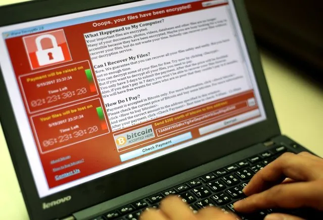 A programer shows a sample of a ransomware cyberattack on a laptop in Taipei, Taiwan, 13 May, 2017. According to news reports, a “WannaCry” ransomware cyber attack hits thousands of computers in 99 countries encrypting files from affected computer units and demanding 300 US dollars through bitcoin to decrypt the files. (Photo by Ritchie B. Tongo/EPA/EFE)