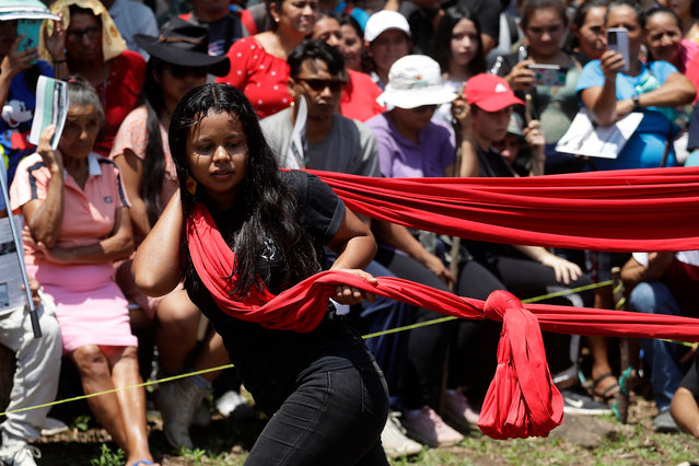 Young people perform a popular theater show dedicated to the victims of the El Sumpul Massacre committed by the Salvadoran army in 1980 during a commemorative act in Ojos de Agua, El Salvador on May 14, 2023. Young supporters and survivors of the massacre of Sumpul, in which more than 600 people were murdered by the Salvadoran Army, commemorated the 43rd anniversary of the event, which has not been investigated nor is there a criminal process to make those responsible known. (Photo by Rodrigo Sura/EPA/EFE)