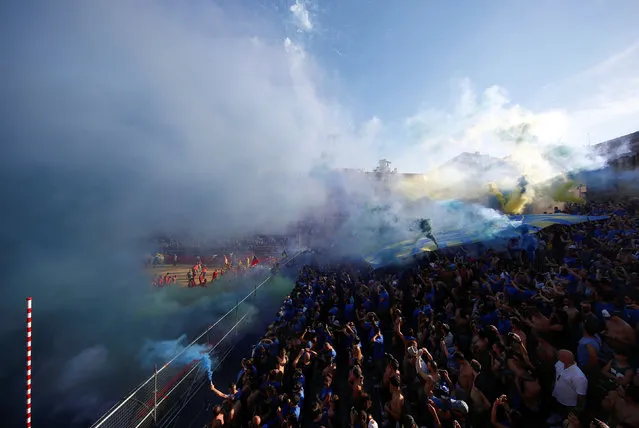 Azzurrii (blue) Santa Croce supporters light flares before the Calcio Fiorentino (historic football) semifinal match against Bianchi (white) Santo Spirito at Santa Croce Square in Florence, Italy, June 11, 2017.  Giovanni de' Bardi published the rules of the game in 1580, which is played on a field of sand by 27 players allowed to use feet and hands to play the ball. (Photo by Alessandro Bianchi/Reuters)