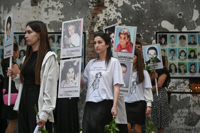 People take part in a procession at the former school, which came under an attack by Islamist militants in 2004 and is currently a centre of patriotic education and terrorism prevention, during a commemoration ceremony marking the 20th anniversary of the deadly school siege in Beslan in the region of North Ossetia–Alania, Russia on September 1, 2024. (Photo by Sergey Pivovarov/Reuters)