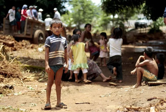 A child stands near others in the village of Punta Caimanes, a place affected by heavy rains in the Izabal region, near Guatemala City, August 8, 2015. (Photo by Josue Decavele/Reuters)