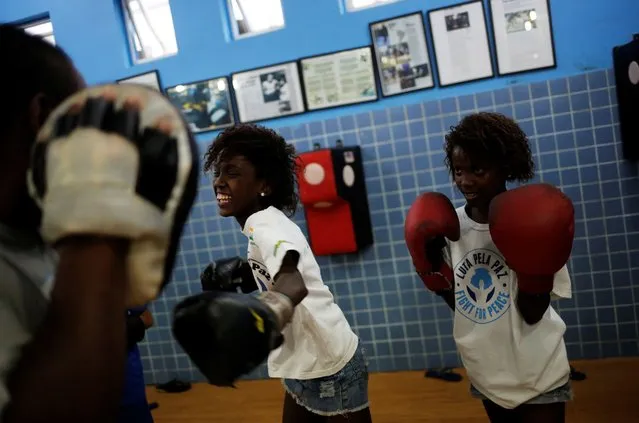 Children practice during an exercise session at a boxing school, in the Mare favela of Rio de Janeiro, Brazil, June 2, 2016. (Photo by Nacho Doce/Reuters)