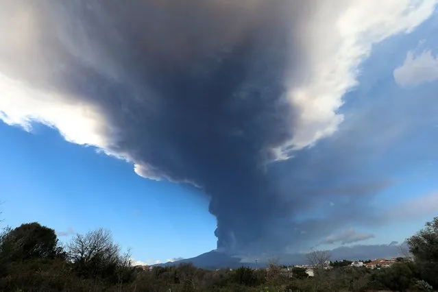 Mount Etna, Europe's highest and most active volcano, erupts and shoots plumes of smoke, seen from Gravina di Catania, Italy, February 21, 2022. (Photo by Antonio Parrinello/Reuters)