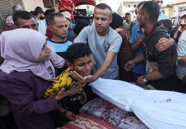 A boy mourns near the body of his father and other Palestinians, who were killed in an Israeli strike, amid the Israel-Hamas conflict, at Al-Aqsa Martyrs Hospital in Deir Al-Balah in the central Gaza Strip, on October 9, 2024. (Photo by Ramadan Abed/Reuters)