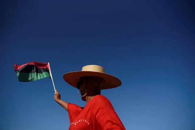 A person waves a flag during an emancipation march as people gather to celebrate Juneteenth, which commemorates the end of slavery in Texas, two years after the 1863 Emancipation Proclamation freed slaves elsewhere in the United States, in Galveston, Texas, U.S., June 19, 2022. (Photo by Callaghan O'Hare/Reuters)