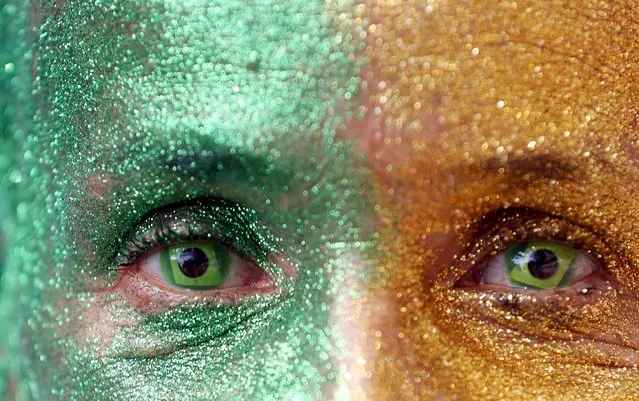 A demonstrator with the design of the national flag in her eyes attends a protest against Brazil's President Dilma Rousseff, part of nationwide protests calling for her impeachment, at Paulista Avenue in Sao Paulo's financial centre, Brazil, August 16, 2015. (Photo by Paulo Whitaker/Reuters)