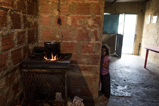 A kid in her house in Barlovento waits for the lunch which is only boiled yam in Caracas, Venezuela on June 22, 2016. The cost of resell food in the black market is 1000% higher  what it cost in the groceries stores. (Photo by Alejandro Cegarra/The Washington Post)
