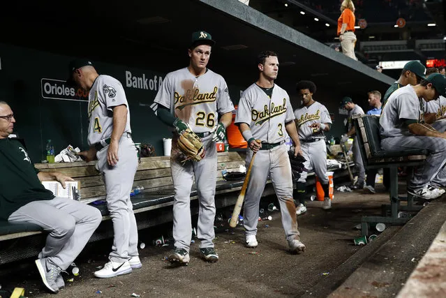 Oakland Athletics' Matt Chapman (26) and Boog Powell (3) walk out of the dugout after a baseball game against the Baltimore Orioles in Baltimore, Monday, August 21, 2017. Baltimore won 7-3. (Photo by Patrick Semansky/AP Photo)